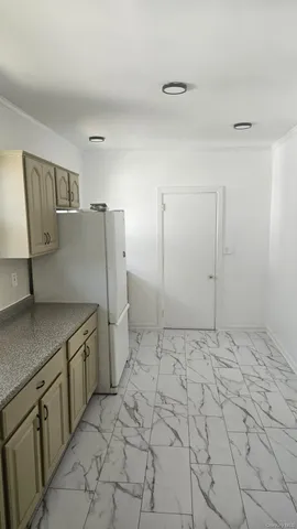 a kitchen with a stove refrigerator and cabinets