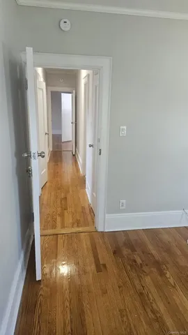 wooden floor with view of bathroom