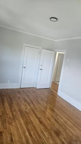 a view of an empty room and wooden floor