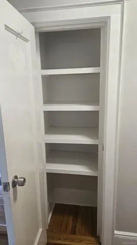 a view of walk in closet with empty racks