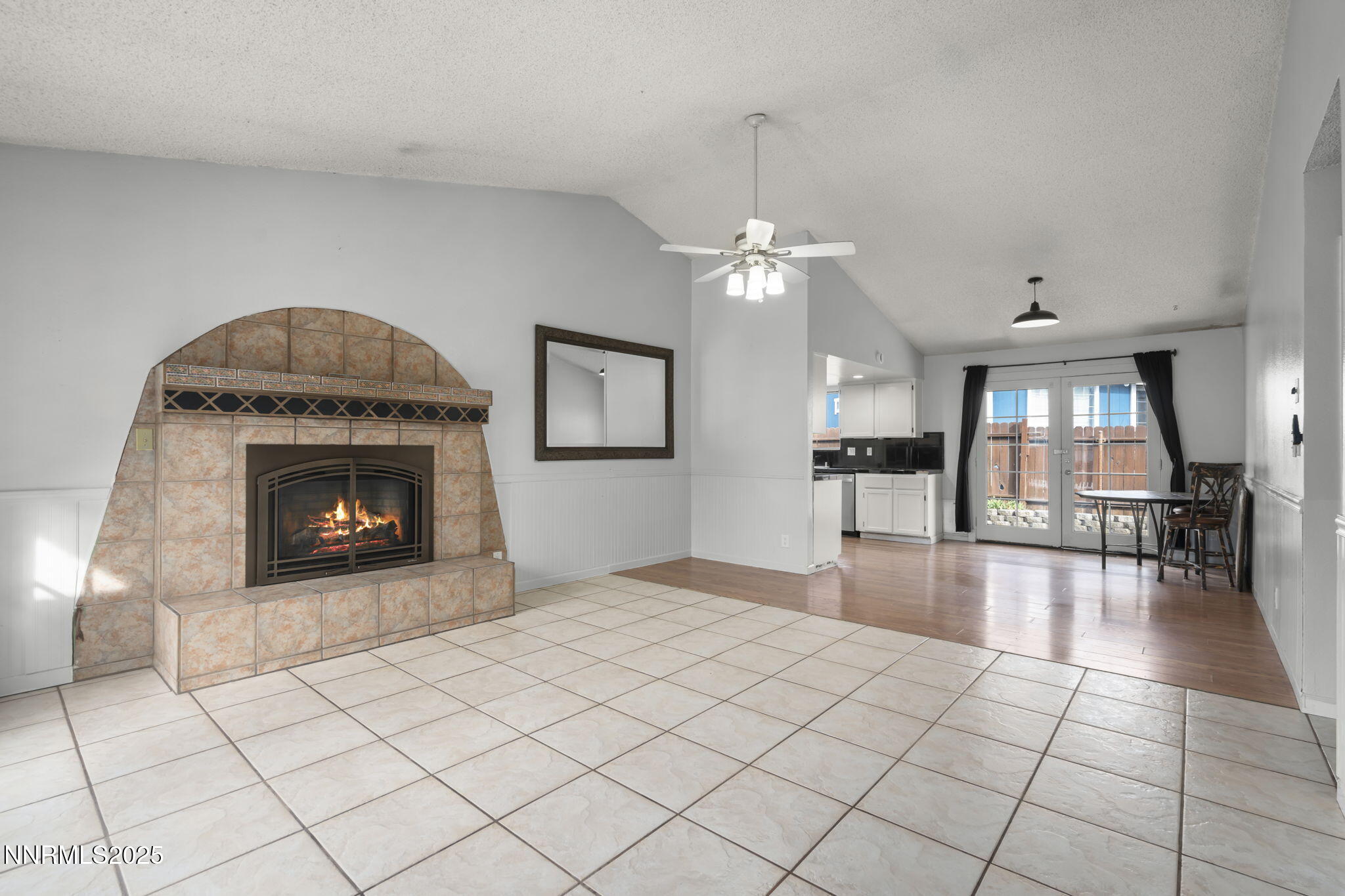 1720 Peavine Road Reno, NV 89503 - Photo 5 of 24 a view of a livingroom with a fireplace a chandelier and windows