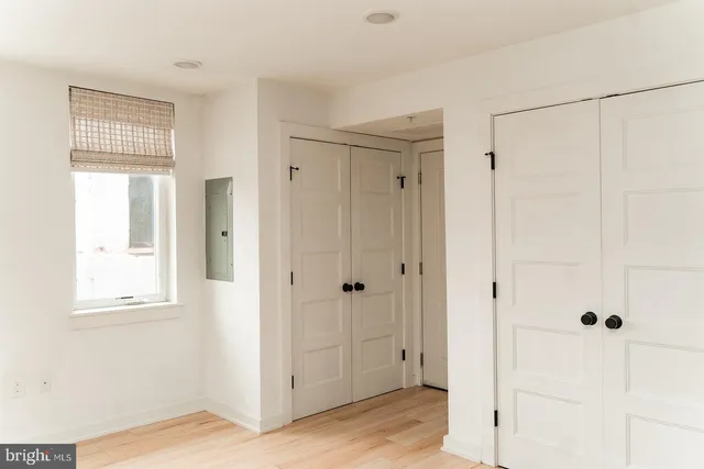 a view of a bathroom with wooden floor and mirror