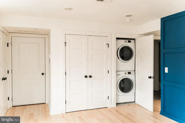 a view of a kitchen with wooden floor and cabinets