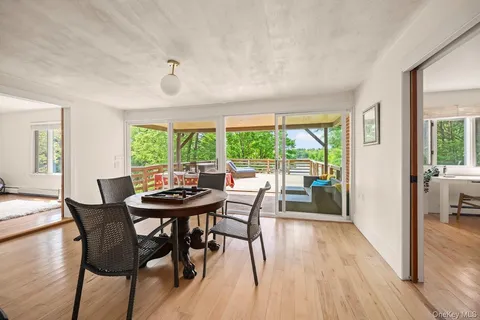 a dining room with furniture and wooden floor