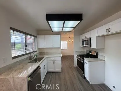 a kitchen with stainless steel appliances a sink stove and cabinets