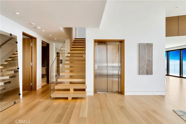 a view of entryway with wooden floor and front door