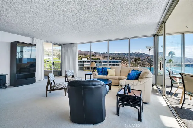 a view of a livingroom with furniture wooden floor and a chandelier