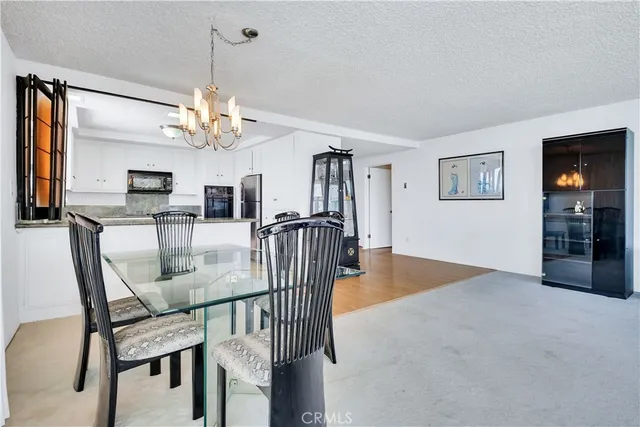 a spacious bedroom with a bed and a view of kitchen