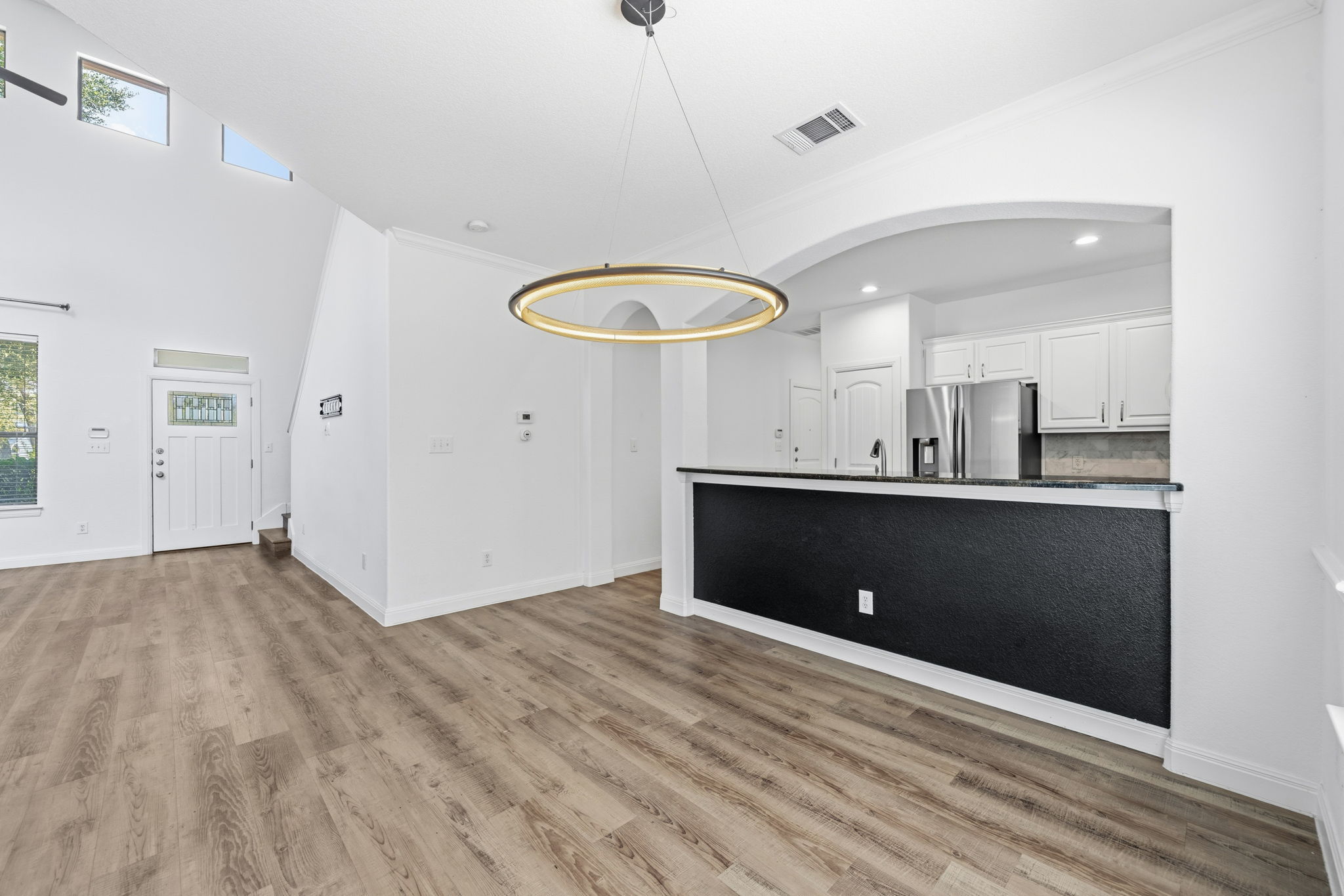 6708 Manchaca Road, Unit 4 Austin, TX 78745 - Photo 25 of 25 An open floor plan connects the dining area to a modern kitchen with breakfast bar.