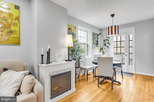 a living room with furniture a chandelier and a table