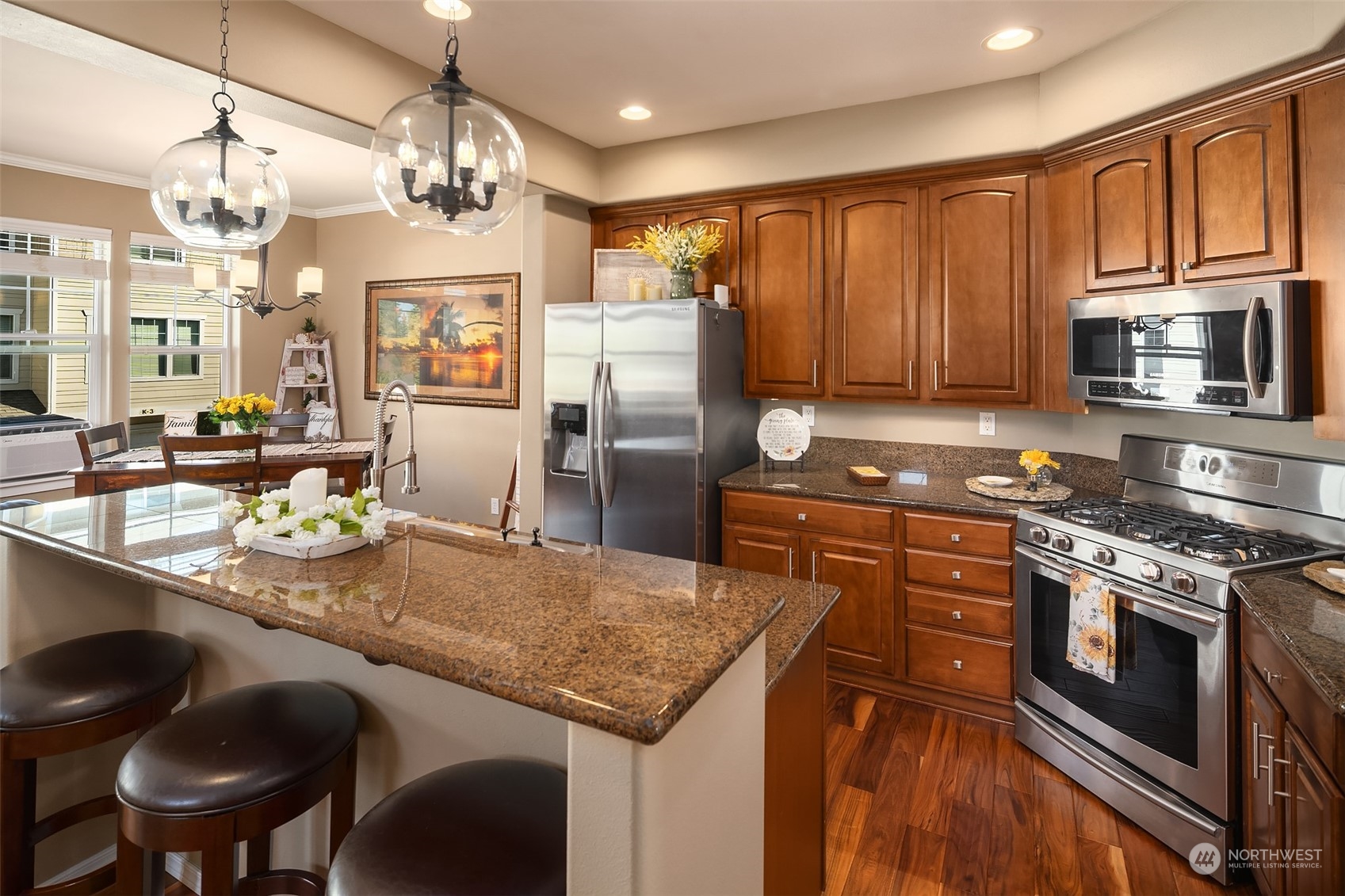 15 164th Street Southwest, Unit H4 Bothell, WA 98012 - Photo 4 of 18 a kitchen with stainless steel appliances granite countertop a stove refrigerator and cabinets