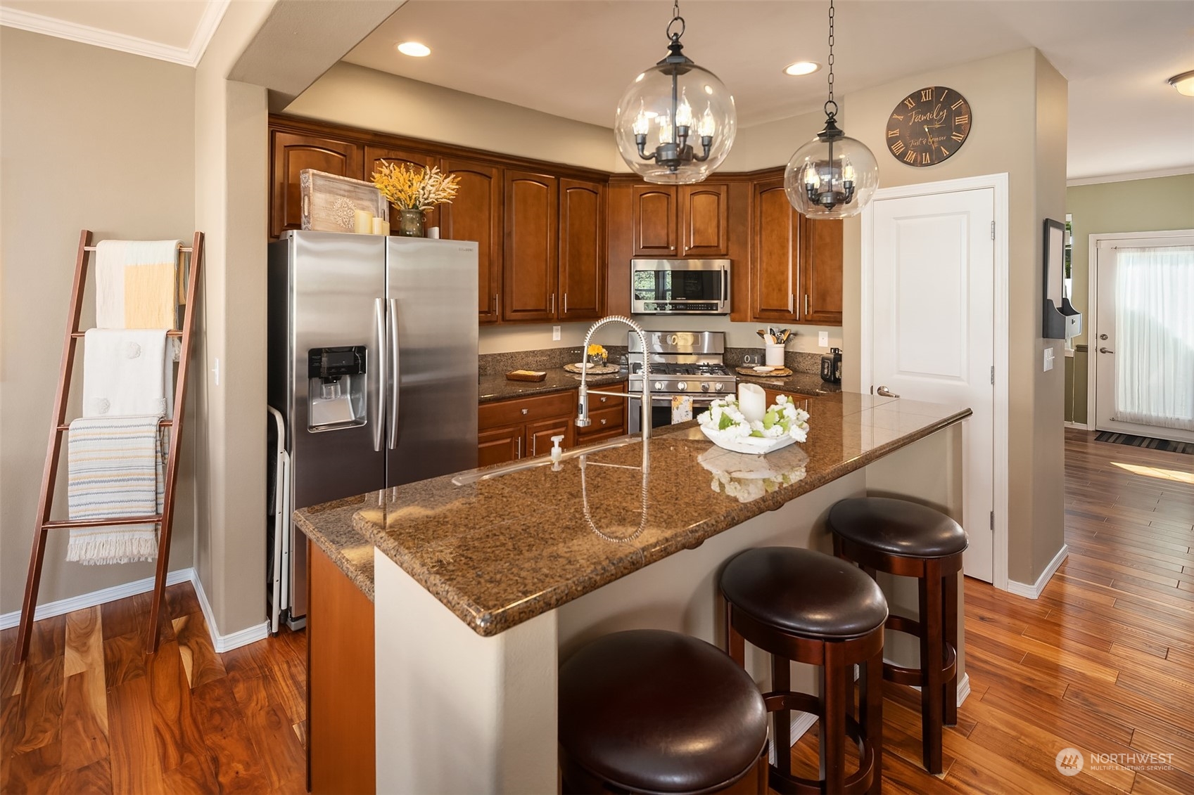 15 164th Street Southwest, Unit H4 Bothell, WA 98012 - Photo 5 of 18 a kitchen with stainless steel appliances granite countertop a table chairs and stove