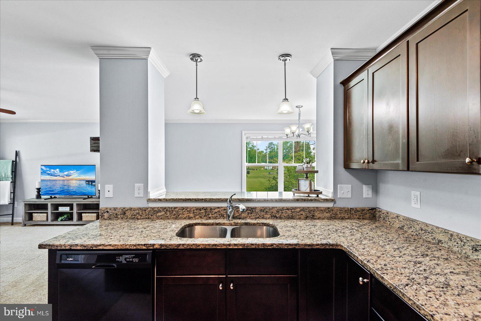 129 Brooks Drive Colonial Beach, VA 22443 - Photo 14 of 40 a kitchen with granite countertop stainless steel appliances window a sink and cabinets