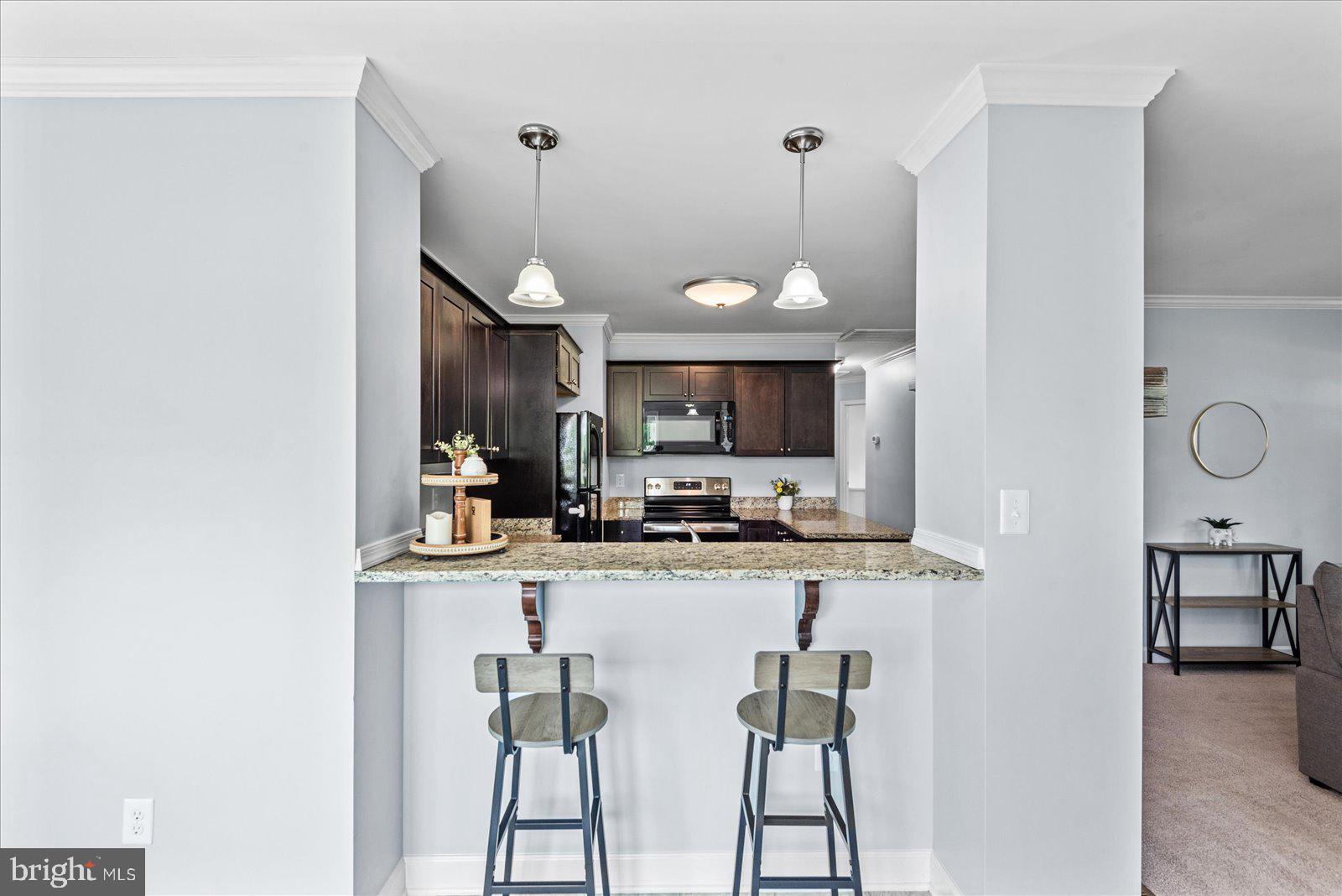 129 Brooks Drive Colonial Beach, VA 22443 - Photo 15 of 40 a kitchen with cabinets and chairs