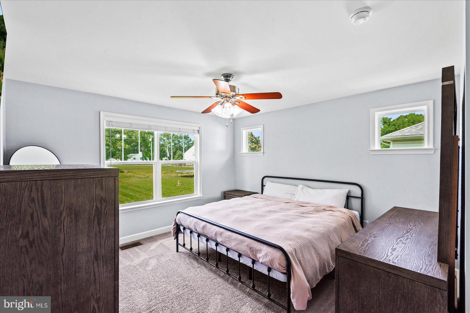129 Brooks Drive Colonial Beach, VA 22443 - Photo 18 of 40 a bedroom with a bed a window and a chandelier