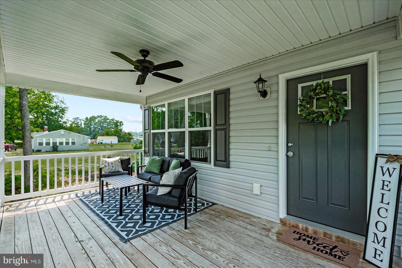 129 Brooks Drive Colonial Beach, VA 22443 - Photo 2 of 40 a view of a deck with table and chairs and wooden floor