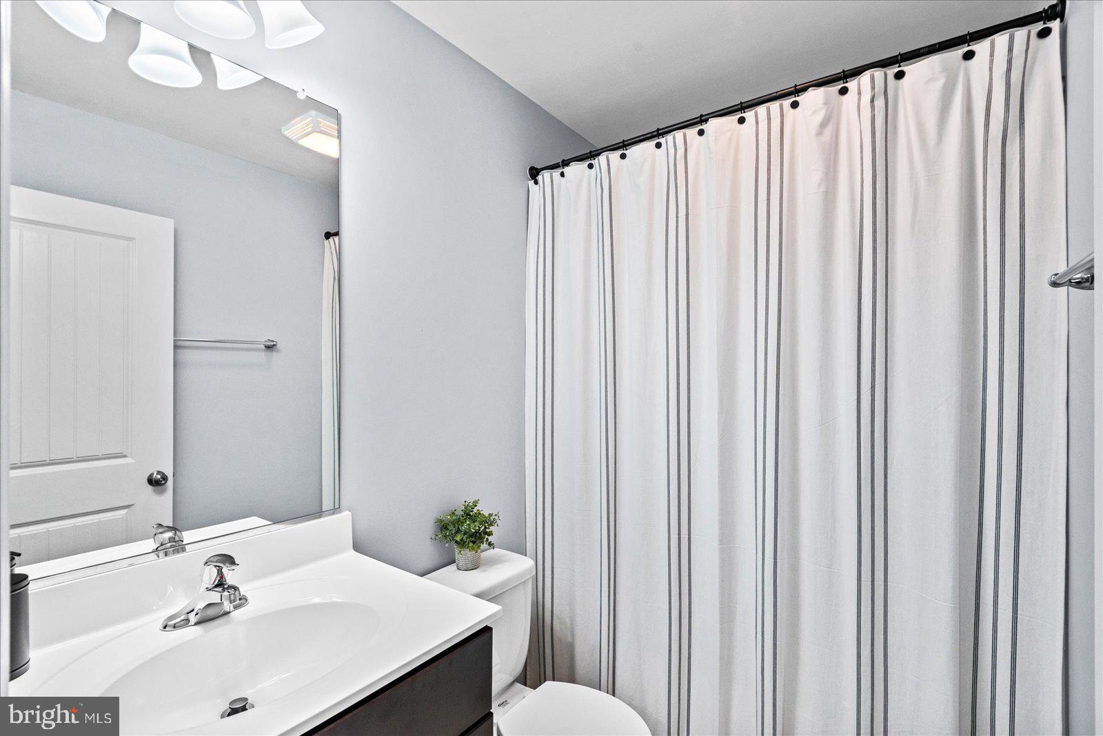 129 Brooks Drive Colonial Beach, VA 22443 - Photo 27 of 40 a bathroom with a sink a mirror and a toilet