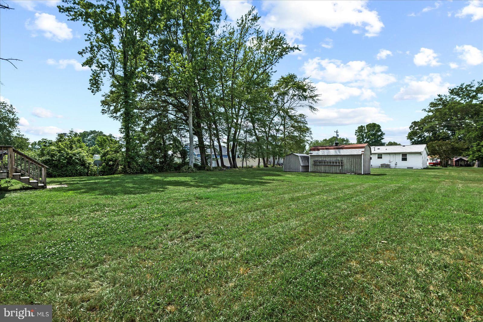 129 Brooks Drive Colonial Beach, VA 22443 - Photo 33 of 40 a view of green field with tree in the background