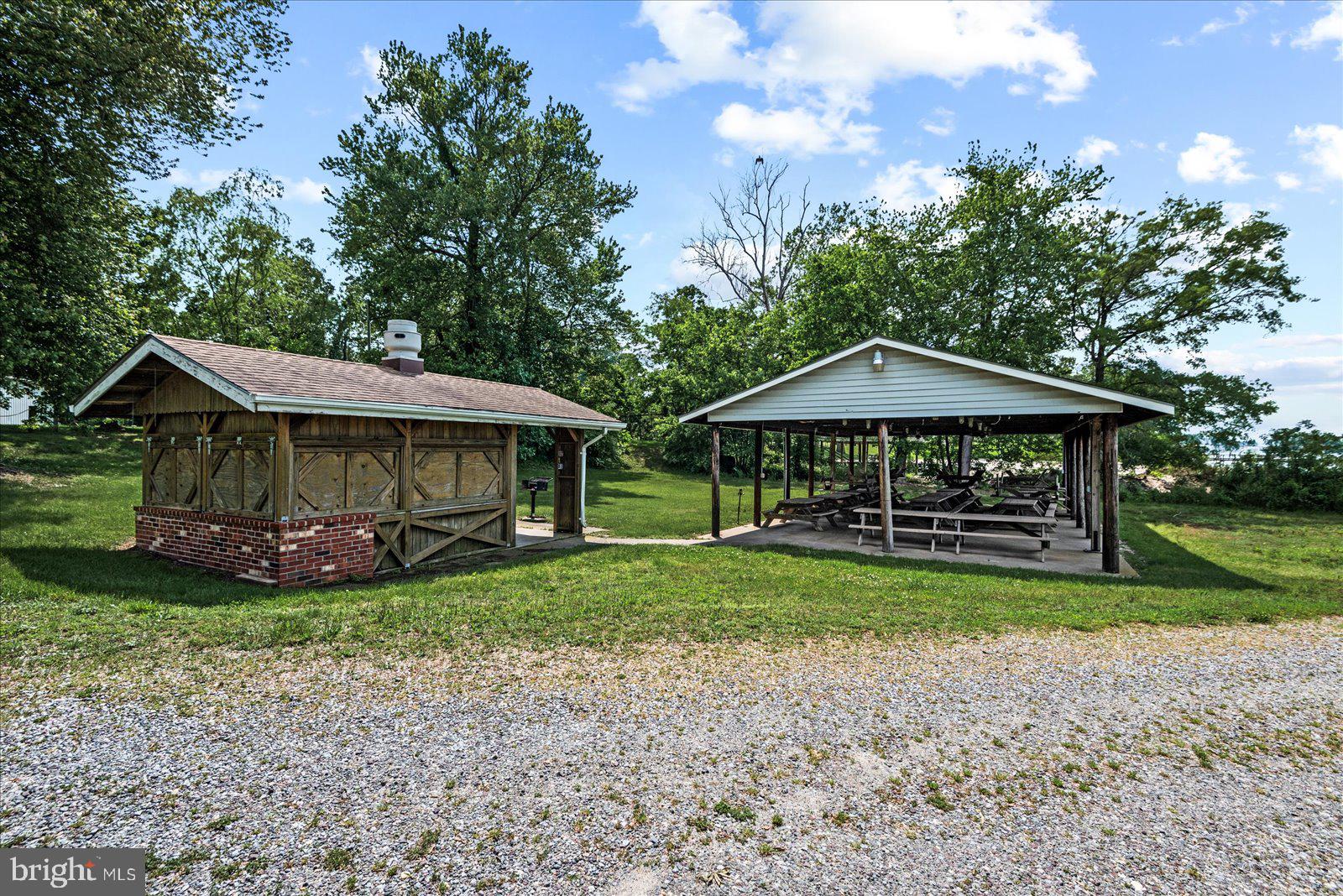 129 Brooks Drive Colonial Beach, VA 22443 - Photo 36 of 40 a view of a wooden house with a yard and sitting area