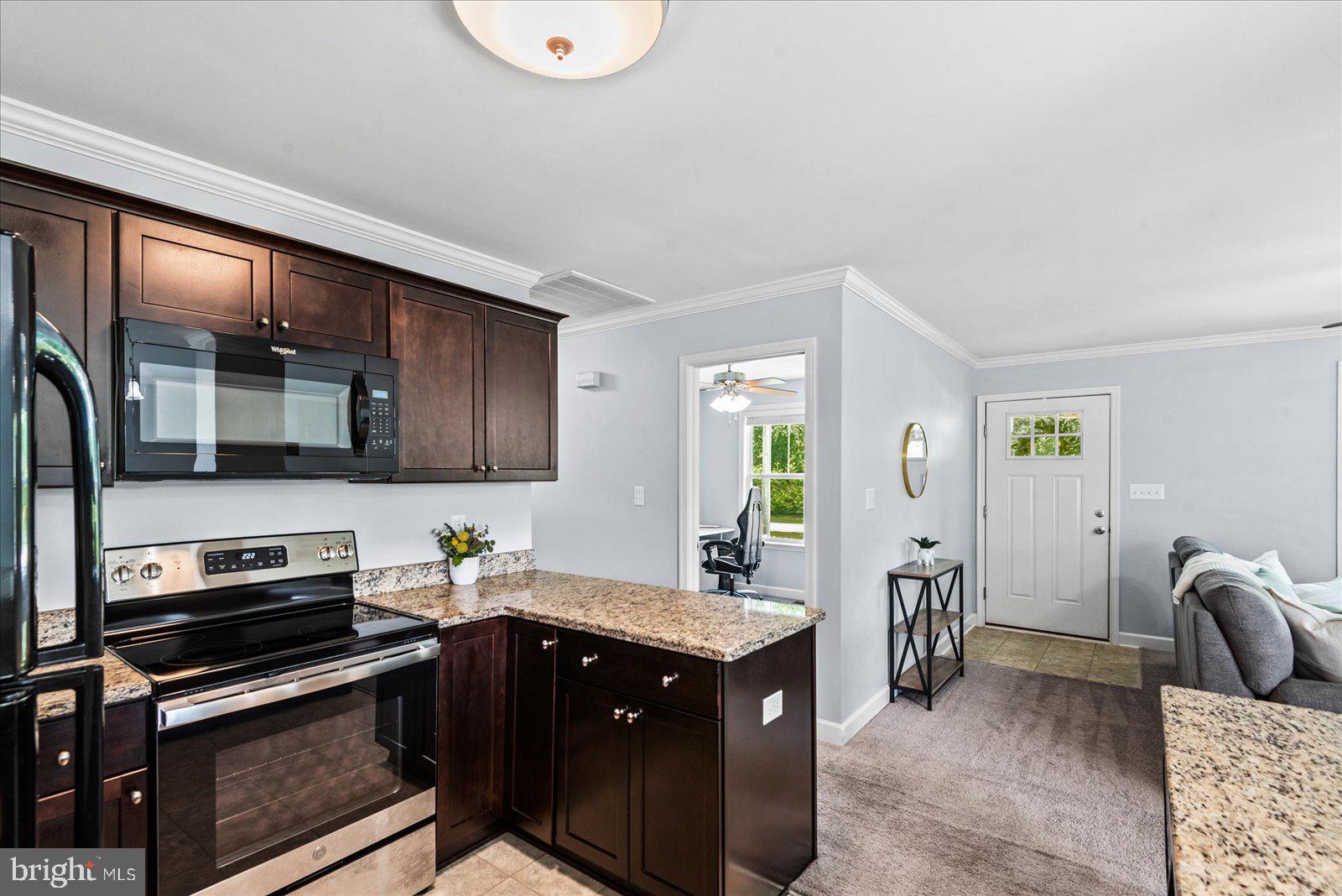 129 Brooks Drive Colonial Beach, VA 22443 - Photo 10 of 40 a kitchen with stainless steel appliances granite countertop a sink stove and cabinets