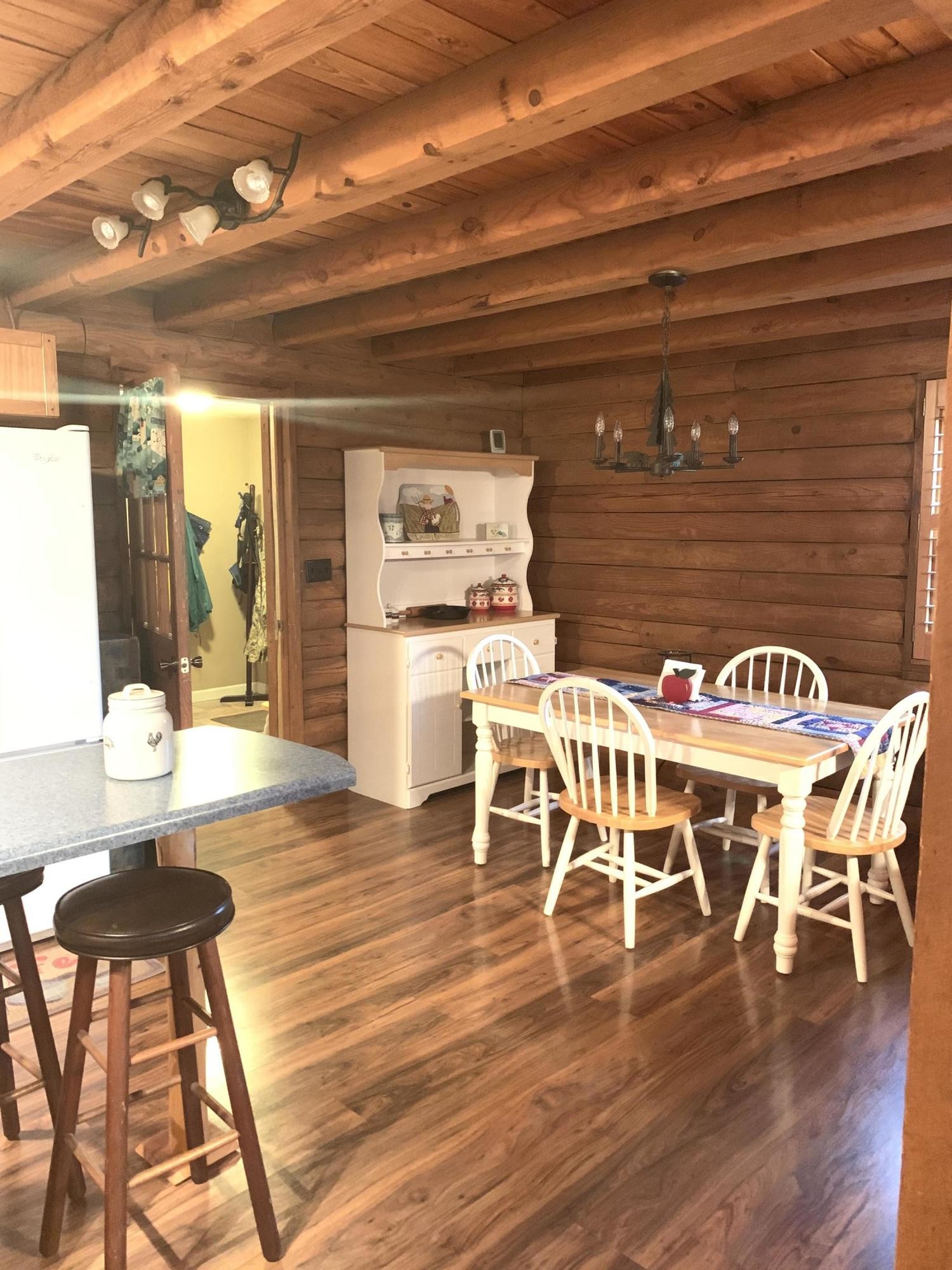 10017 Rutledge Pike Corryton, TN 37721 - Photo 15 of 38 a dining room with wooden floor a glass table and chairs