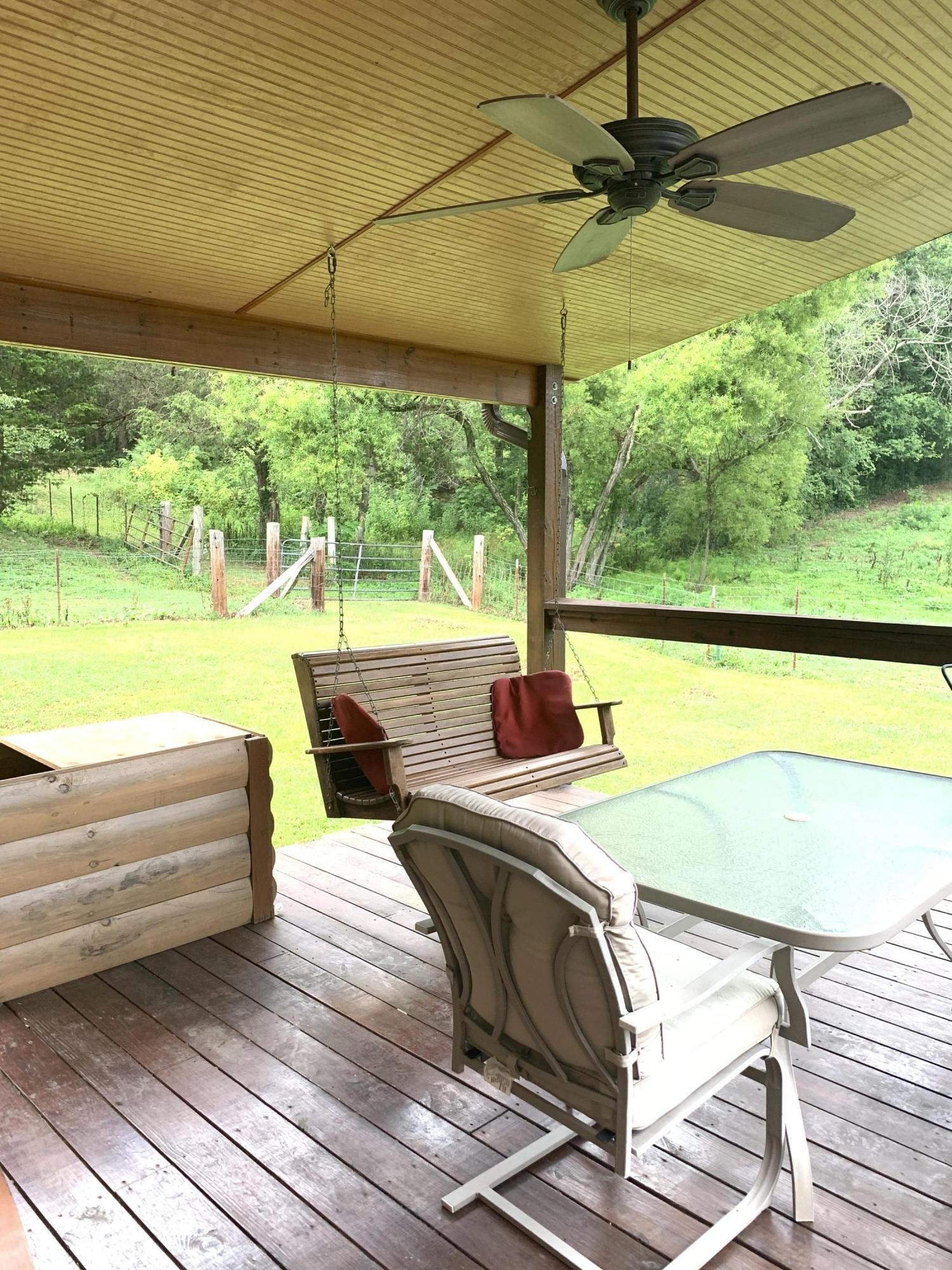10017 Rutledge Pike Corryton, TN 37721 - Photo 21 of 38 a view of a patio with lawn chairs under an umbrella