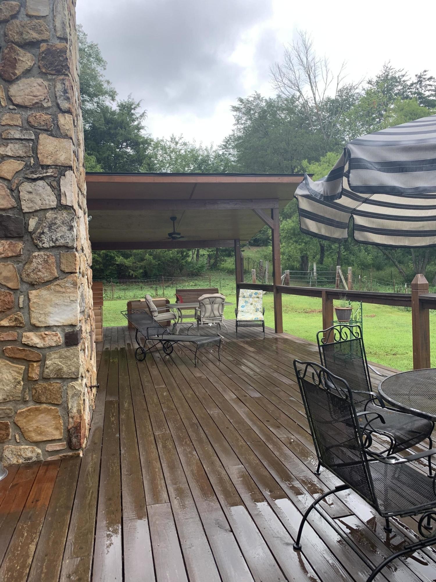 10017 Rutledge Pike Corryton, TN 37721 - Photo 29 of 38 a view of a patio with table and chairs wooden floor and fence