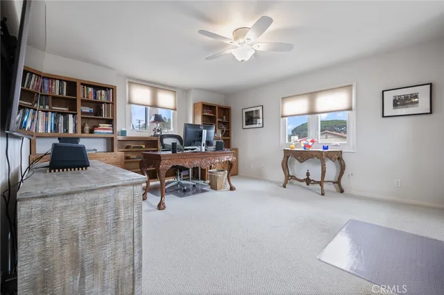 a living room with furniture and a book shelf