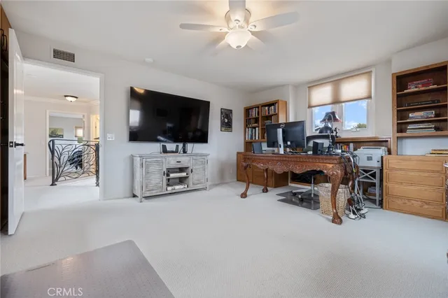 a view of a livingroom with workspace and a window