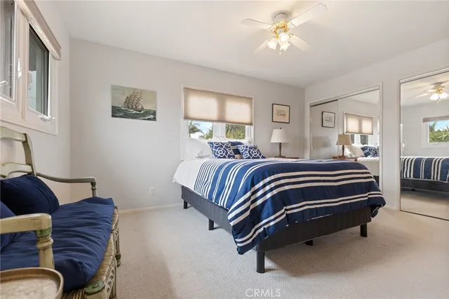 a bedroom with a bed couch and a window