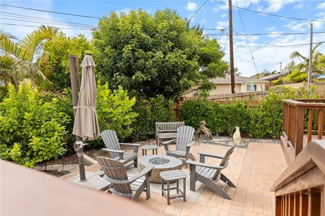 a view of a patio with a table and chairs and potted plants
