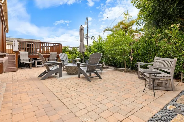 a view of a patio with a table and chairs under an umbrella
