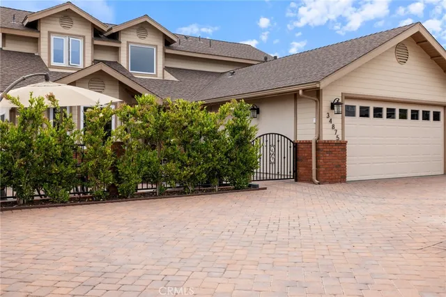 a house with a small yard and palm trees