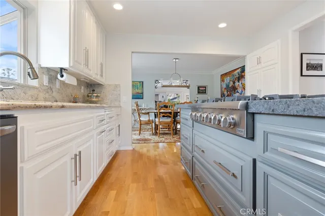 a kitchen with stainless steel appliances granite countertop a stove and a sink