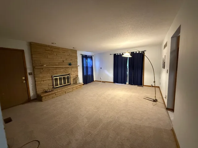 a view of an empty room with a fireplace