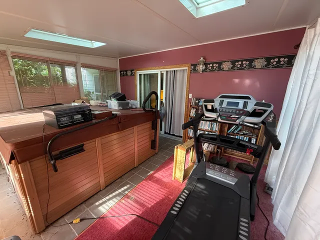 a dining room with furniture and a floor to ceiling window