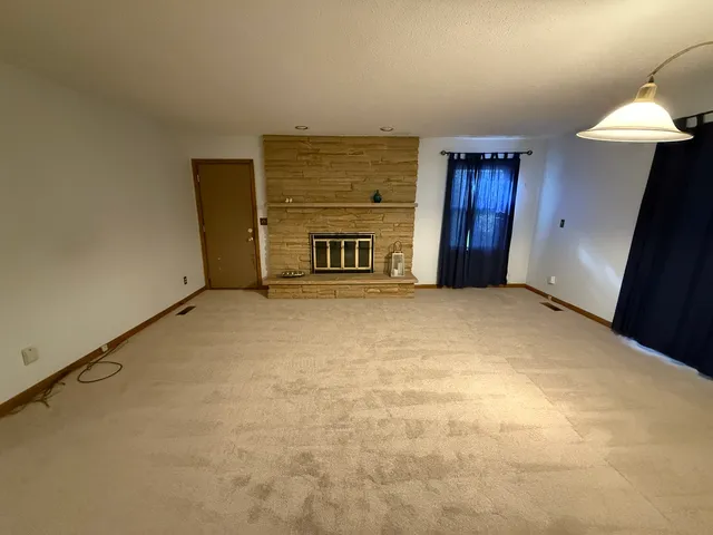 a view of an empty room with a fireplace