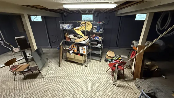 a living room with furniture and a gym machine