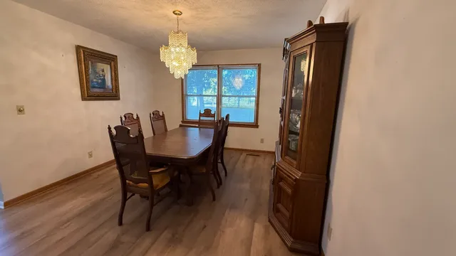 a view of a dining room with furniture and window