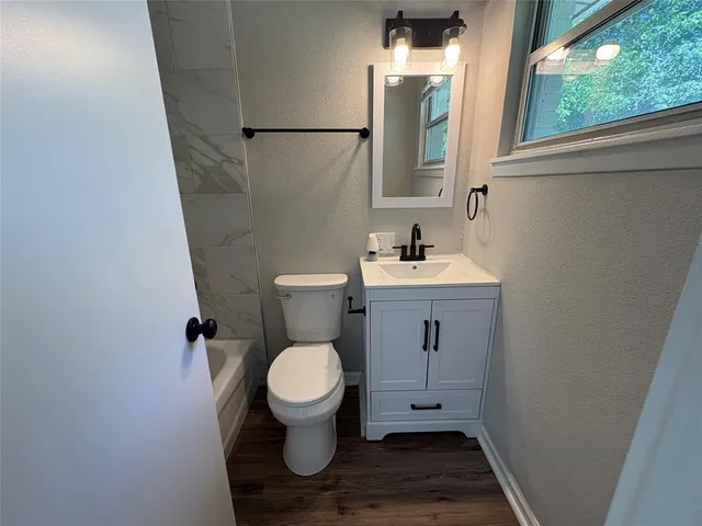a bathroom with a toilet sink and mirror