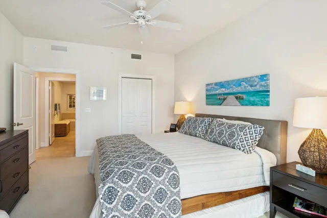 a bedroom with a large bed and a chandelier