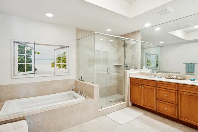 a bathroom with a bathtub shower sink and mirror