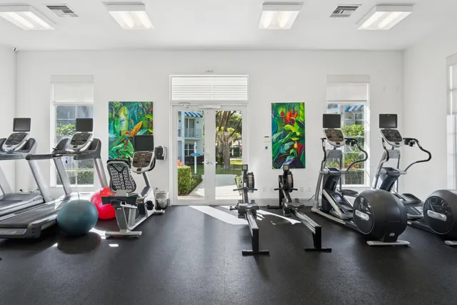 a view of a swimming pool with a yard and palm trees
