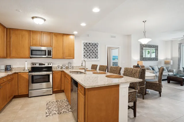 a kitchen with a stove a sink a dining table and chairs