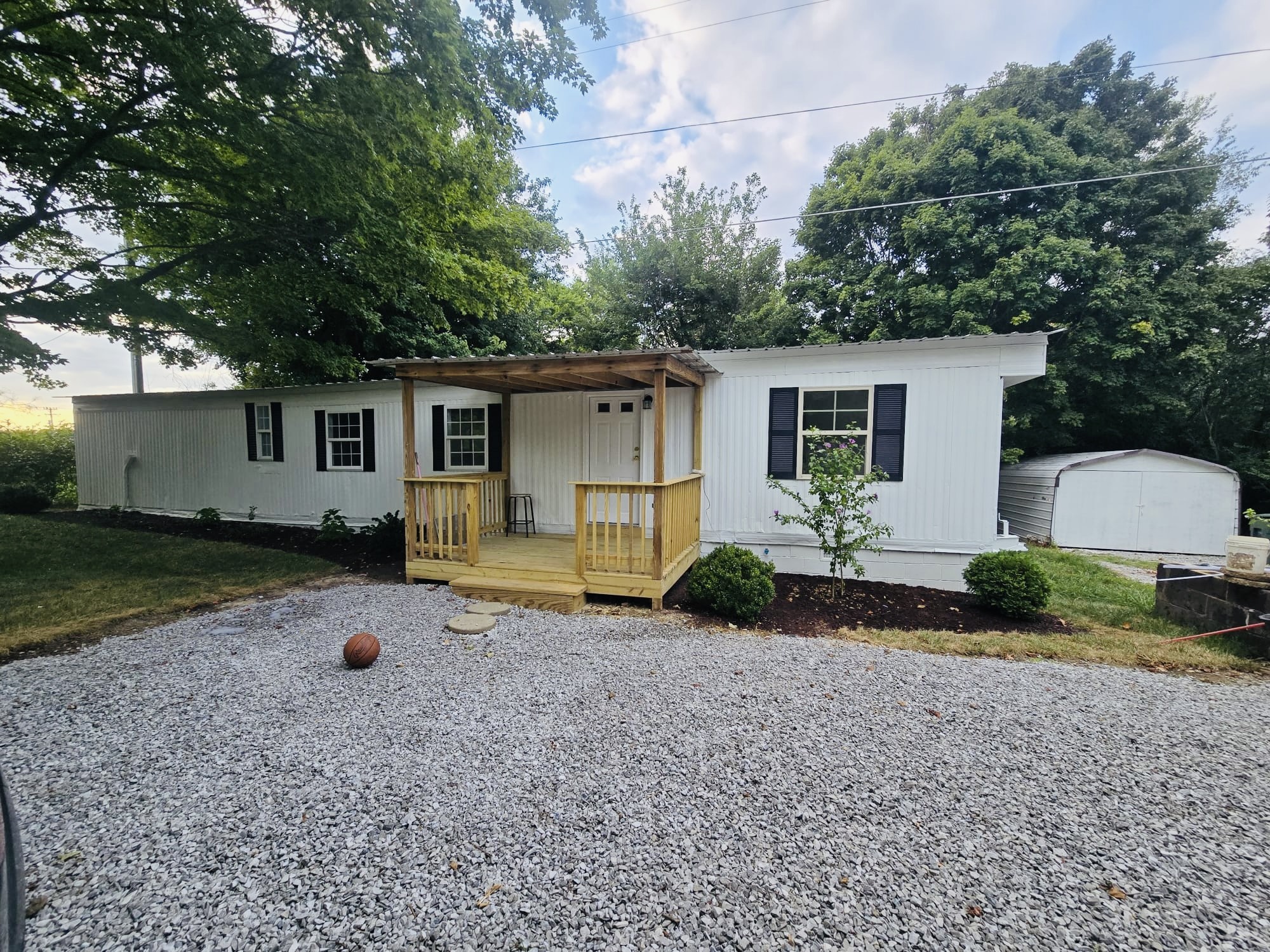 a view of a house with backyard and a tree
