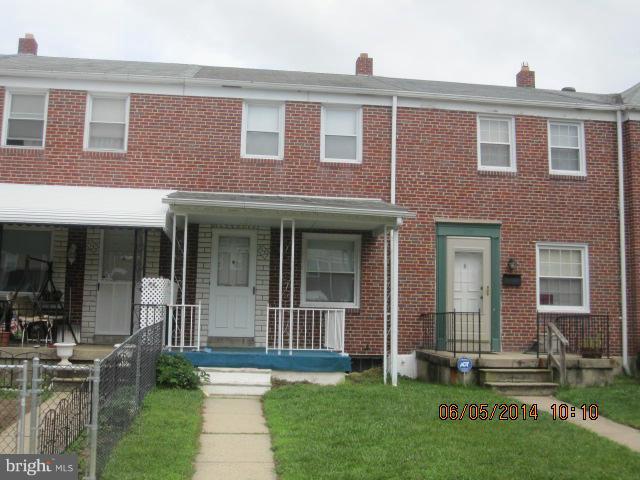 2137 Redthorn Road Baltimore, MD 21220 - Photo 1 of 9 front view of a brick house with a yard and table and chairs next to window
