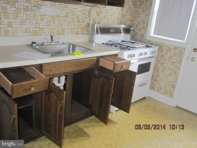2137 Redthorn Road Baltimore, MD 21220 - Photo 2 of 9 a kitchen with stainless steel appliances kitchen island a stove a sink and a refrigerator