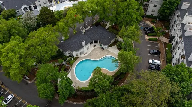 an aerial view of a house with swimming pool and outdoor space
