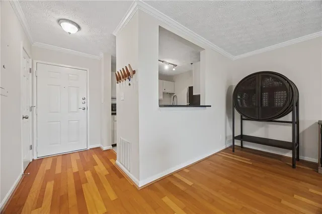 a view of a livingroom with wooden floor and furniture