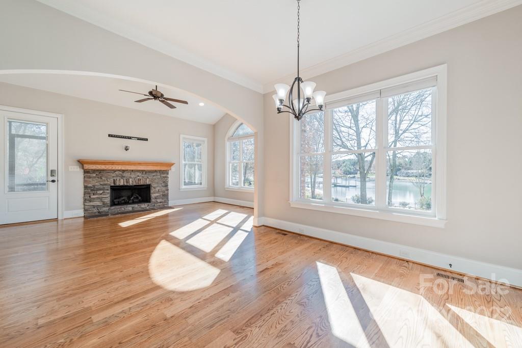 144 Greyfriars Road Mooresville, NC 28117 - Photo 18 of 43 a view of an empty room with wooden floor fireplace and a window